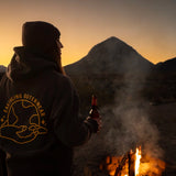 Earthling hoodie worn by a campfire