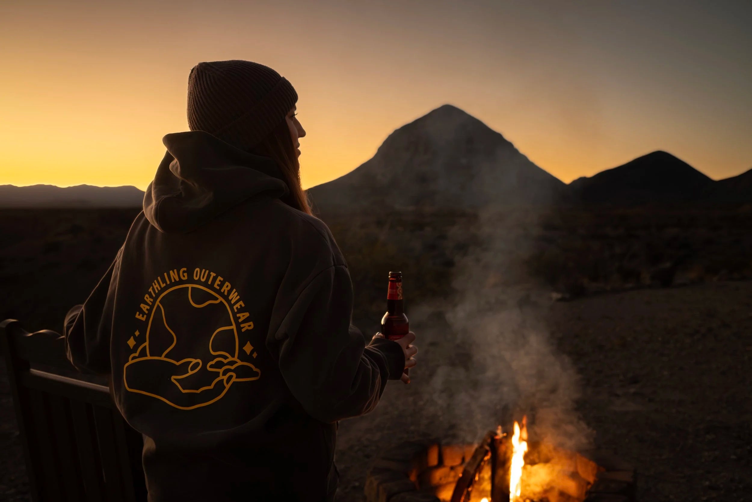 Earthling hoodie worn by a campfire