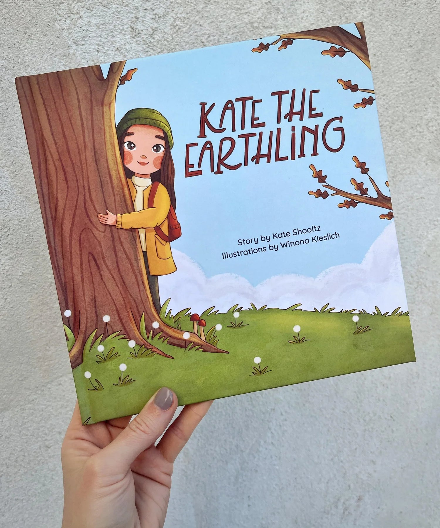 Kate the Earthling children's book held in hand