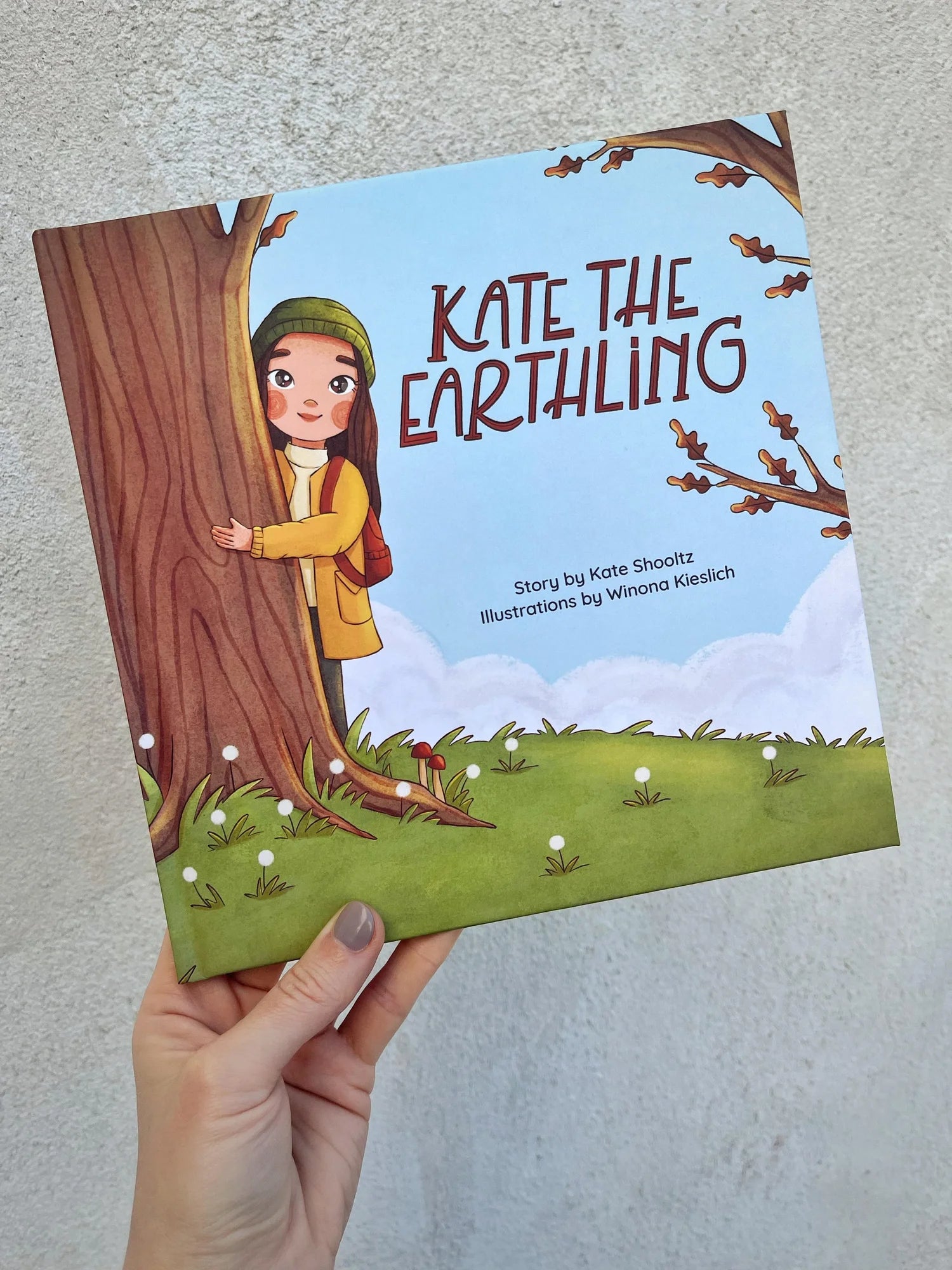 Kate the Earthling children's book held in hand
