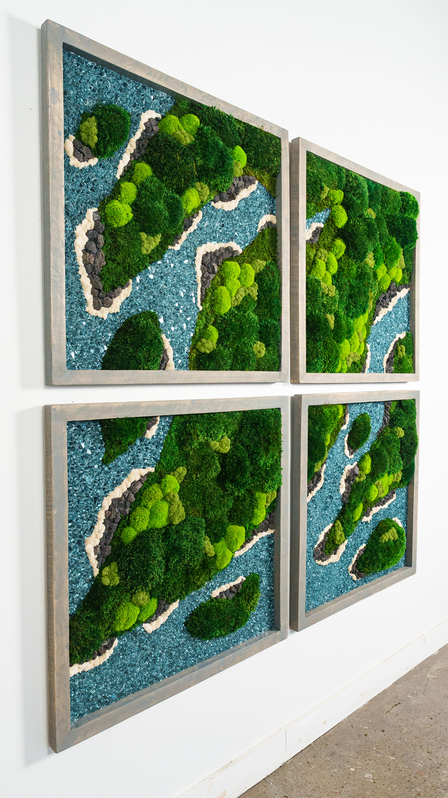 Multi-panel preserved moss artwork with blue waterways winding across green moss